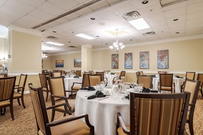 Elegant dining room with set tables and artwork