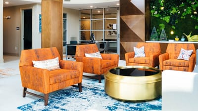 Bright and modern common area with orange chairs