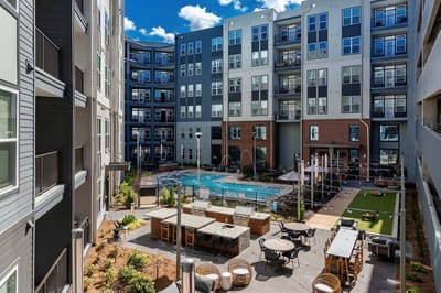 Outdoor pool area with seating and landscaping