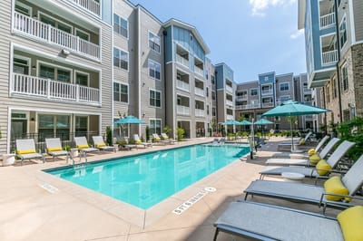 Outdoor pool area with lounge chairs and umbrellas