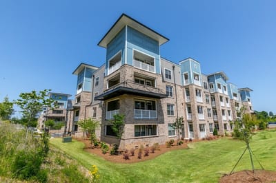 Exterior view of a senior living facility with green space