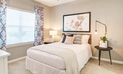 Cozy bedroom setup with light decor and natural light