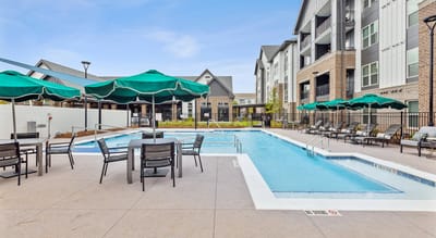 Outdoor pool area with lounge chairs and umbrellas