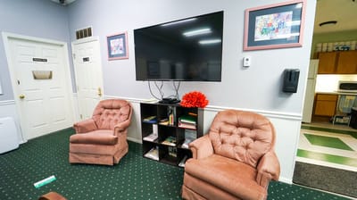 Cozy common area with chairs and a TV