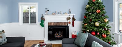 Cozy common area with a Christmas tree and fireplace