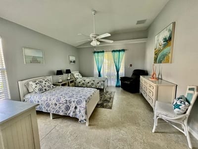 Brightly decorated resident room with two beds and natural light