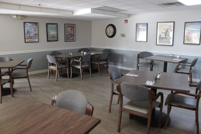 Dining room with wooden tables and framed art