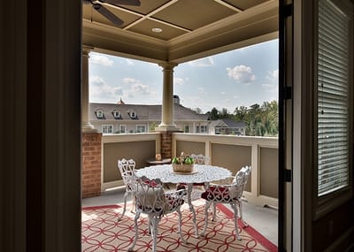 Interior view of a balcony with a table and chairs