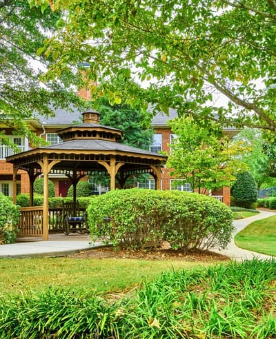 Outdoor gazebo surrounded by greenery in a senior living community