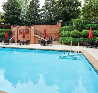 Resort-style pool area with lounge chairs and umbrellas