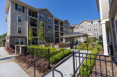 Exterior view of a senior living facility with landscaped gardens