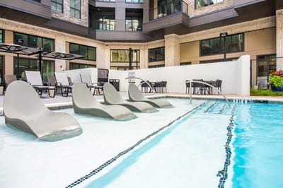 Modern pool area with lounge chairs in a courtyard