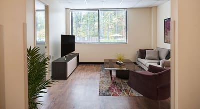 Cozy lounge area with a sofa and TV