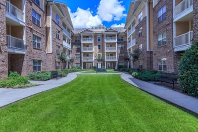Outdoor courtyard with grass and seating areas
