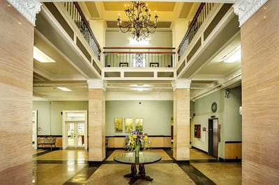 Interior view of a spacious lobby with a chandelier