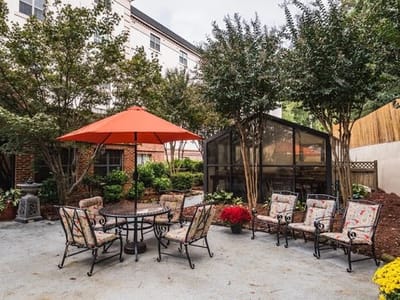 A serene outdoor space with seating and an umbrella