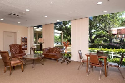 Bright common area with seating and large windows