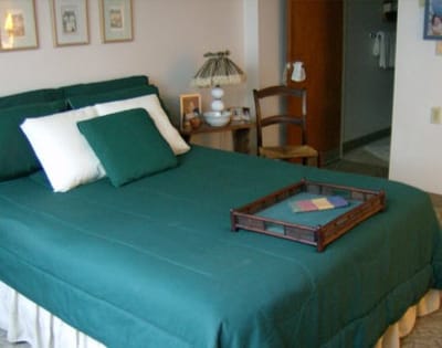 Cozy bedroom setup with green bedding and a tray