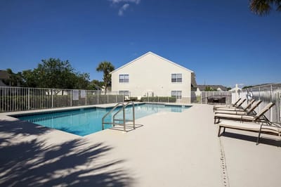 Outdoor swimming pool area with lounge chairs