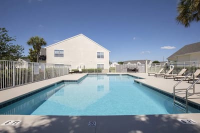 Outdoor swimming pool area with lounge chairs