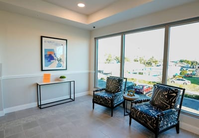 Bright interior waiting area with modern chairs and art