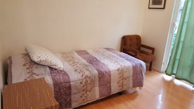 Private resident room with a bed and chair