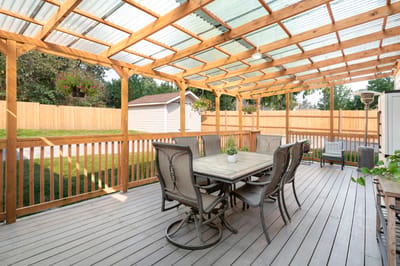Outdoor patio area with a dining table and chairs