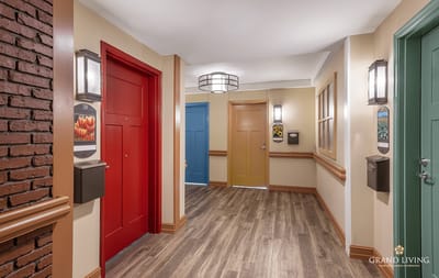 Interior hallway with colorful doors and light fixtures