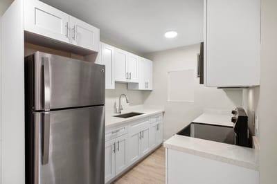 Modern kitchen with white cabinets and stainless steel appliances