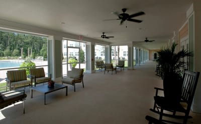 Covered outdoor seating area with a view of the pool