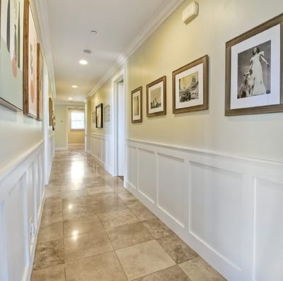 Well-lit interior hallway with framed art