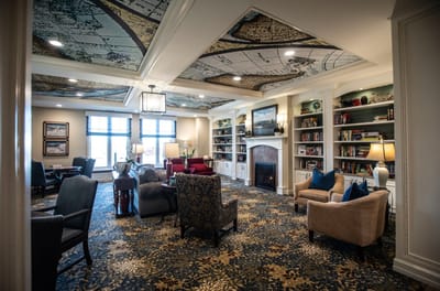 Comfortable common area with a fireplace and bookshelves