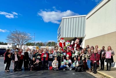 A large group celebrating outside the facility