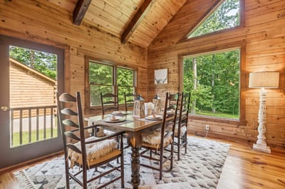 Cozy dining area with wooden decor and large windows