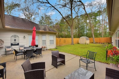 Outdoor seating area with wicker furniture and red umbrella