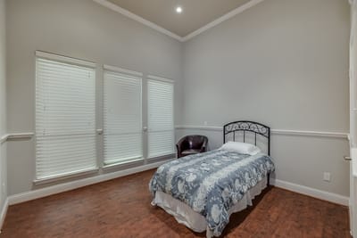 Cozy bedroom with a bed and chair near windows