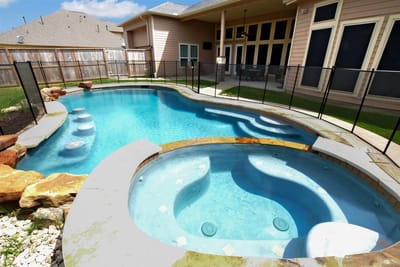 A pool and spa area in an outdoor space