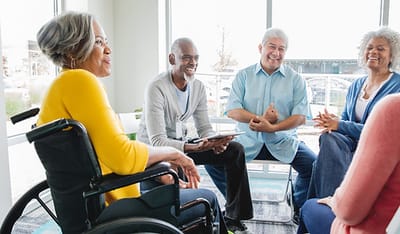 Residents engaged in conversation in a common area.
