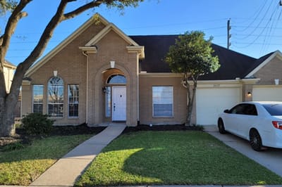 Exterior view of a residential building with yard.