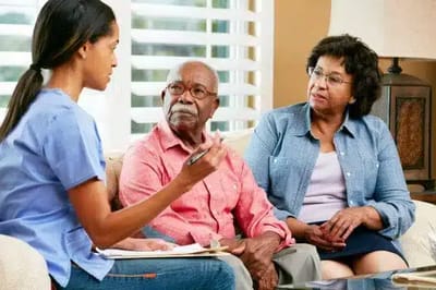 Staff member consulting with elderly residents