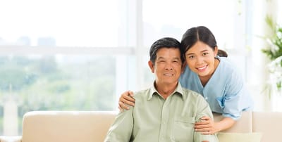 Resident and caregiver smiling together