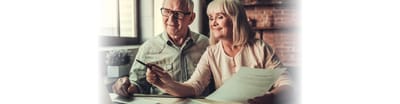 A happy senior couple reviewing documents together.