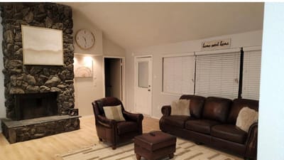 Cozy living room with stone fireplace and clock