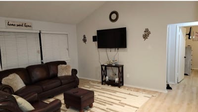 Cozy living room with leather furniture and wall decor.