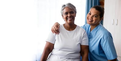 Senior woman smiling with caregiver