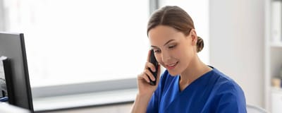 Nurse on the phone in an office setting.