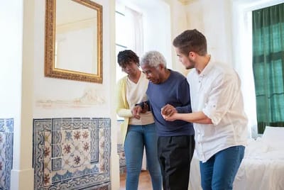 Staff assisting a resident in a bright room