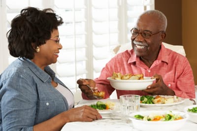 Elderly couple enjoying a meal together.