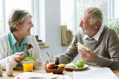Two seniors enjoying a meal together