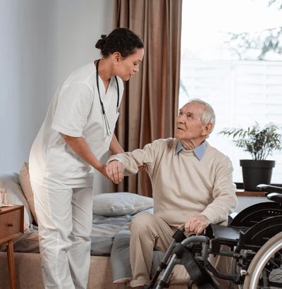 Nurse assisting senior in a room.